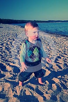 Cute toddler playing on beach