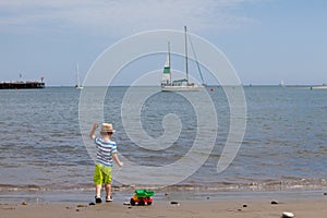 Cute toddler playing on the beach