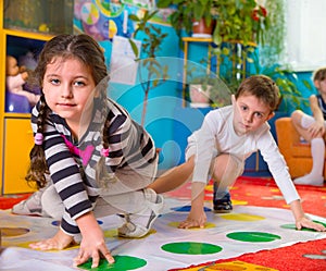 Cute toddlers playing in twister game photo