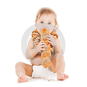 Cute todler eating long bread