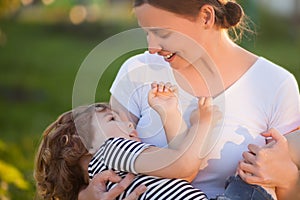 Cute toodler girl on her mothers hands