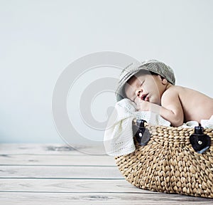 Cute tot sleeping in a basket