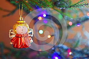 Cute toy angel girl on xmas tree