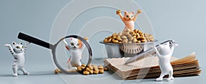 Cute toy kittens next to bowl, dry cat food, notebook, magnifier and pen. Ð¡oncept of choosing the best pet food. Ð¡oncept of