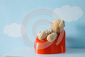 Cute toy sitting on the potty