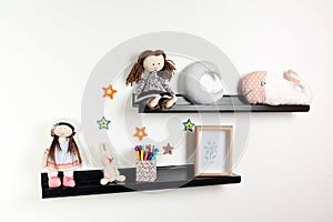 Cute toys and picture on shelves