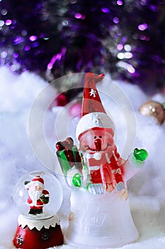 Cute toys of snowman and santa claus on blurred snowy backgrou