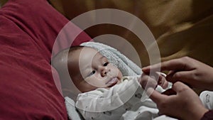 Cute tree months old baby boy making funny faces close up head shoot