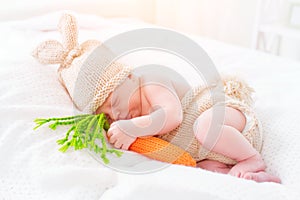 Cute two weeks old newborn baby boy wearing knitted bunny costume