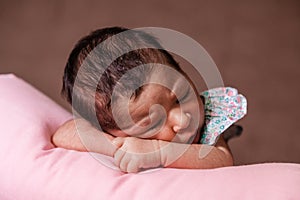 Cute two weeks old newborn baby girl sleeping peacefully