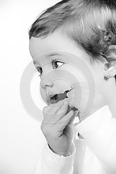 Cute two year old baby eating chocolate