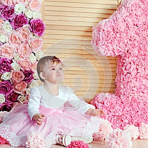 Cute upset baby girl in pink dress