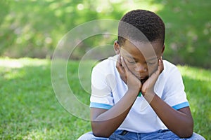 Cute upset boy pouting in the park