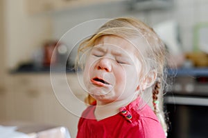 Cute upset unhappy toddler girl crying. Angry emotional child shouting. Portrait of kid with tears.