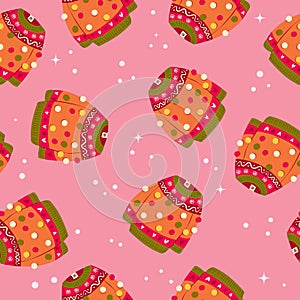 Cute vibrant hand drawn sweater with winter decoration and pom-poms seamless pattern. Colorful holiday vector illustration on pink