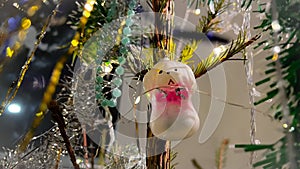 Cute vintage CHristmas ornament in shape of white poodle hanging on live fir tree. Retro toy dog on Xmas tree. Christmas