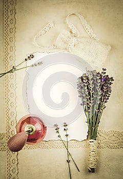 Cute vintage style old pink spray perfume bottle with dry lavender sachet, with bouquet of fresh lavender flowers.