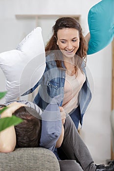 Cute white couple having pillow fight