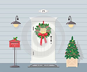 Cute white front door with Christmas wreath, lanterns, Christmas tree and mailbox