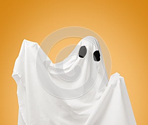 Cute white ghost on Halloween holiday.