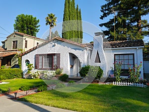 Cute  white Spanish stucco house with large front yard
