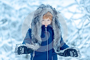 Cute Winter boy in frosty winter Park. Enjoying nature wintertime. Winter at countryside. Winter kids leisure. People in