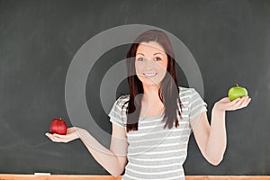 Cute woman with an apple on each hand