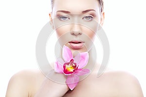 Cute woman with clean skin and pink flower