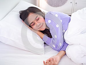 Cute woman eyes closed and sleeping on white soft pillow