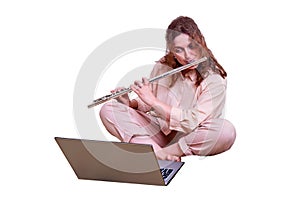 Cute woman flutist plays a musical instrument, isolated on a white bac
