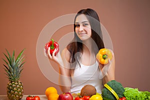 Cute woman with fresh vegetables and fruits leading a healthy lifestyle