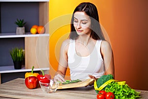 Cute woman with fresh vegetables and fruits leading a healthy lifestyle.