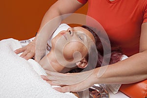 Cute woman gets professional facial massage, lymphatic drainage
