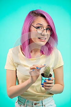 Cute woman girl with a small cactus.