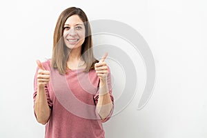 Cute woman in her 40s with thumbs up