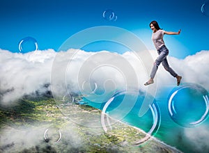 Cute woman jumping in the sky on big soap bubbles