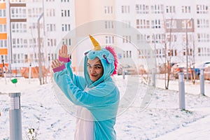 Cute woman in kigurumi unicorn costume