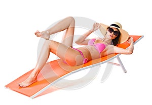 Cute woman on orange sunbed