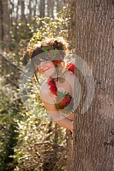 Cute Woman Peeking Out From Behind Tree