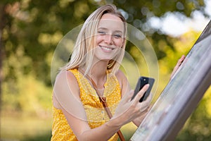 cute woman reading pleasant text message on mobile phone