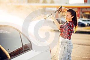 Cute woman on self service carwash