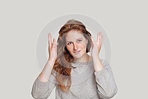 Cute woman shacking her hands on white studio background