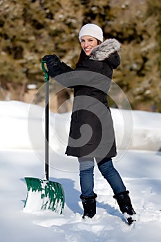 Cute Woman shoveling snow