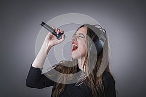 Cute woman singing karaoke