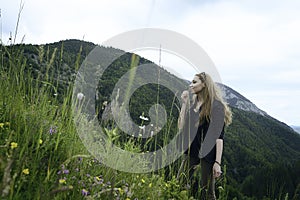 Cute woman smelling a flower