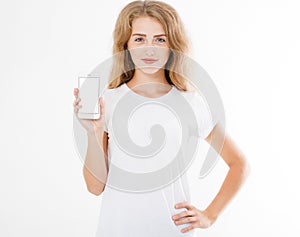 Cute woman in t shirt hold blank screen cell phone isolated on white background. Arm holding smartphone, copy space