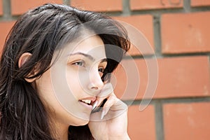 Cute woman talking cellphone closeup