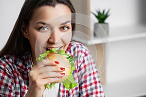 Cute woman wants to eat hamburger harmful