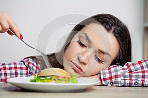Cute woman wants to eat hamburger harmful