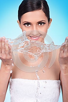 Cute woman wash her face with water